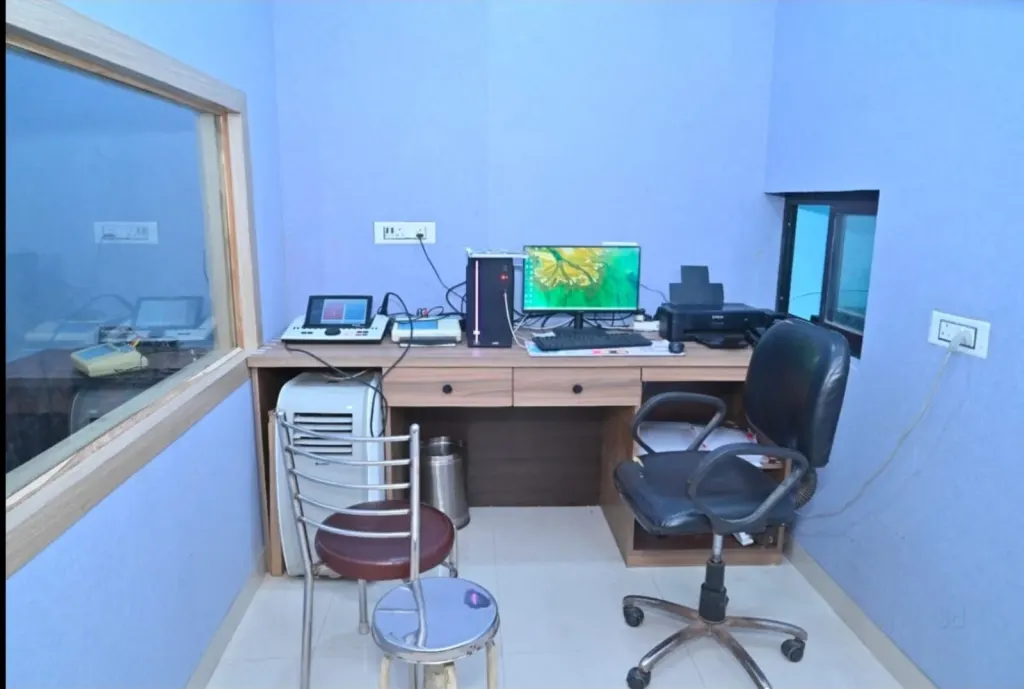 Soundproof audiology room with audiometer and testing booth window